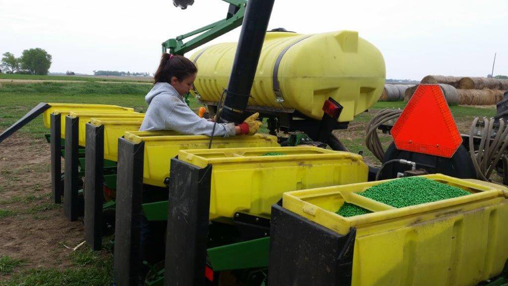 Jaclynn Knutson filling soybean planter