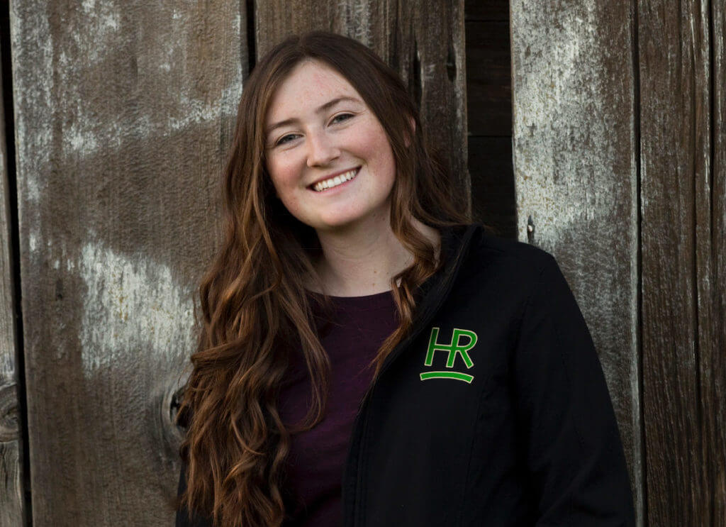 Josie Hamilton standing in front of wooden building